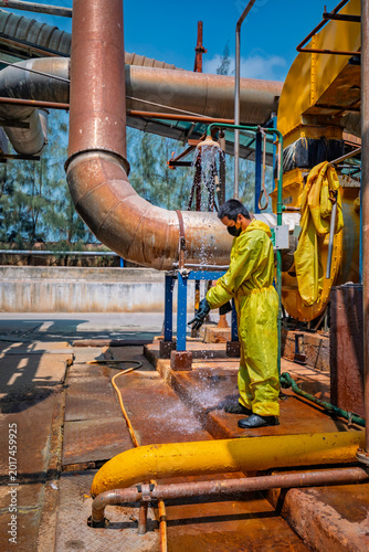 Canvas Print Male workers dressing in protective shower detoxification suit clean up after se