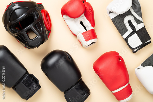 Принти на полотні Boxing helmet and gloves on color background, top view.