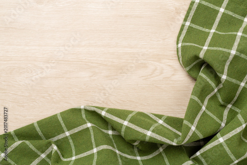 Kitchen napkin on wooden background, top view