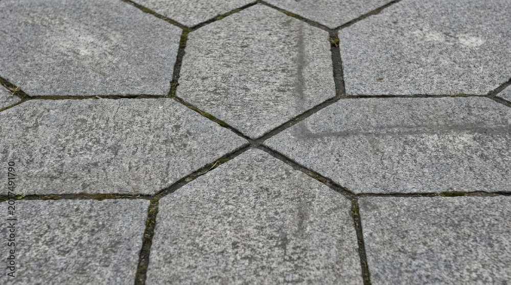 Obraz premium Meticulously Laid Hexagonal Granite Paving Stones Forming a Textured Ground Surface
