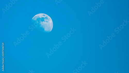 Fotografie Detailed megazoom (600mm) summer view of the moon with craters during daytime wi