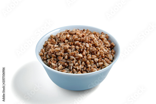 Tableau sur toile boiled buckwheat groats in a blue bowl isolated on white background
