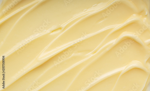 Foto Abstract background of creamy yellow texture with smooth ripples and swirls, thi