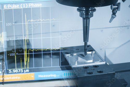 Abstract industrial technology concept featuring a CNC milling machine integrated with a data graph monitor in a blue-toned scene.