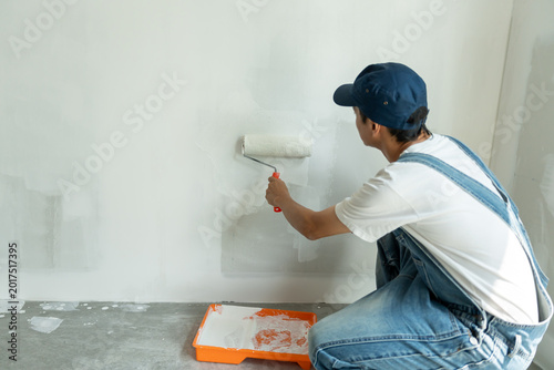 Tableau sur toile painter man, brush in hand for products to restore and paint the wall, indoor th