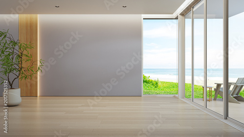 Minimalist living room with cozy armchair and green plant 3d rendering. Blue sky ocean beach view through large glass door of calm interior for vacation relaxation.