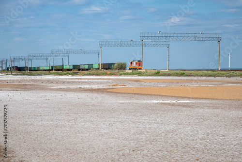 Foto Freight train on the dam of the salt lake Baskunchak
