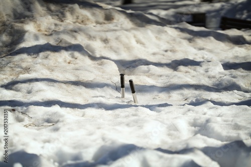 Handles on metal poles sticking out from deep snow covering a completely buried sports ground.
