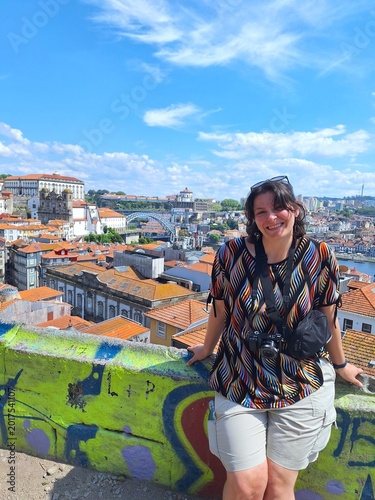 Woman enjoying the iew of old porto on a sunny day