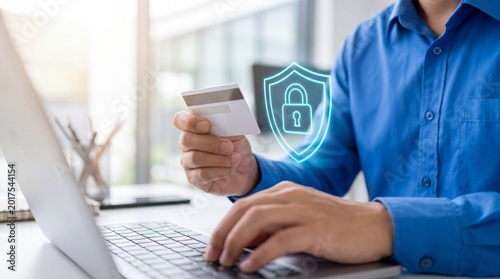 Person holding credit card while using laptop with digital security shield icon for online payment