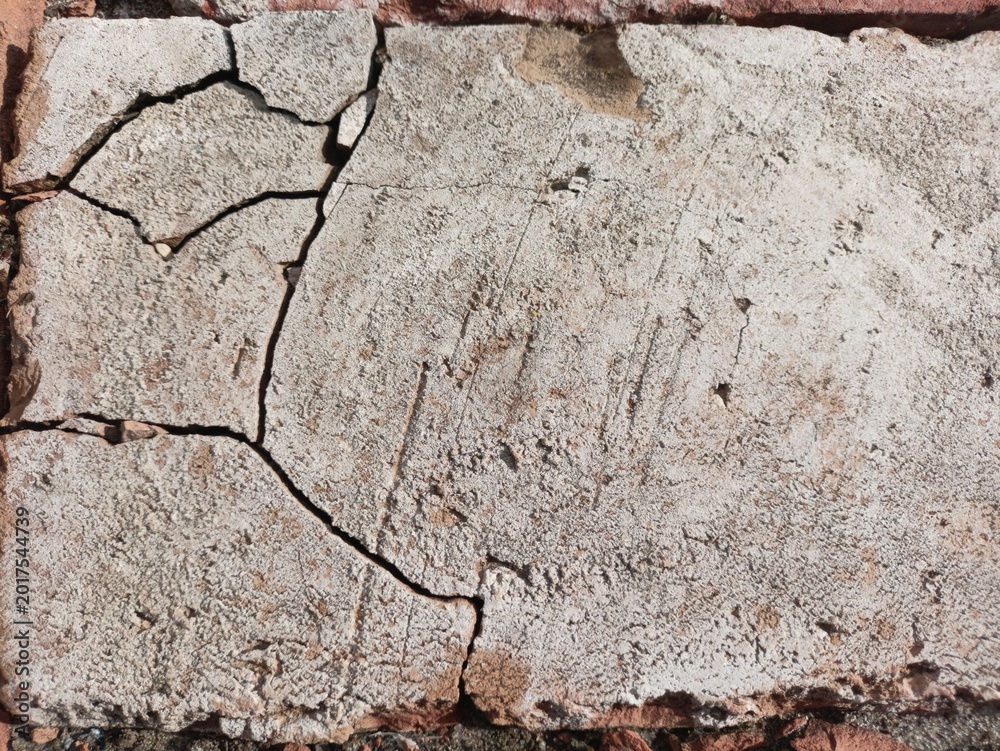 Fototapeta premium Natural light stone brick with deep cracks and weathered surface texture