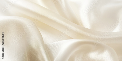 Foto Abstract luxury cream silk fabric background with soft flowing satin waves and e