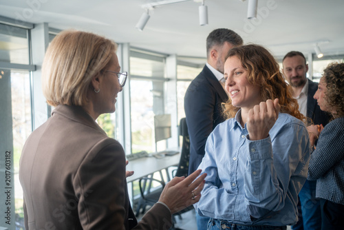 Photos Business women having a constructive conversation during a break in a meeting