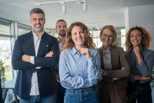 Diverse business team smiling and posing confidently together for camera