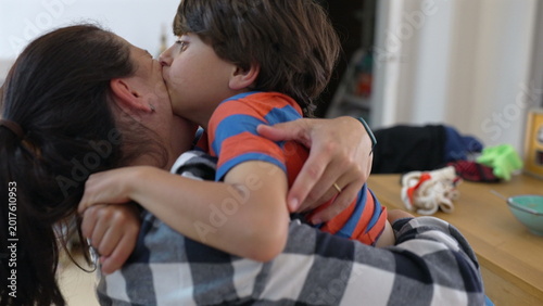 Foto Mother and son exchanging affectionate kiss in warm embrace, expressing mutual l