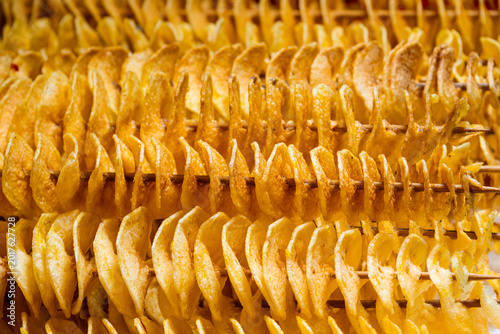 Macro of skewed deep fried potatoes in spiral form