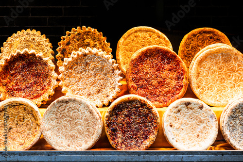 Variations of bread with different ingredients and colours in circular forms