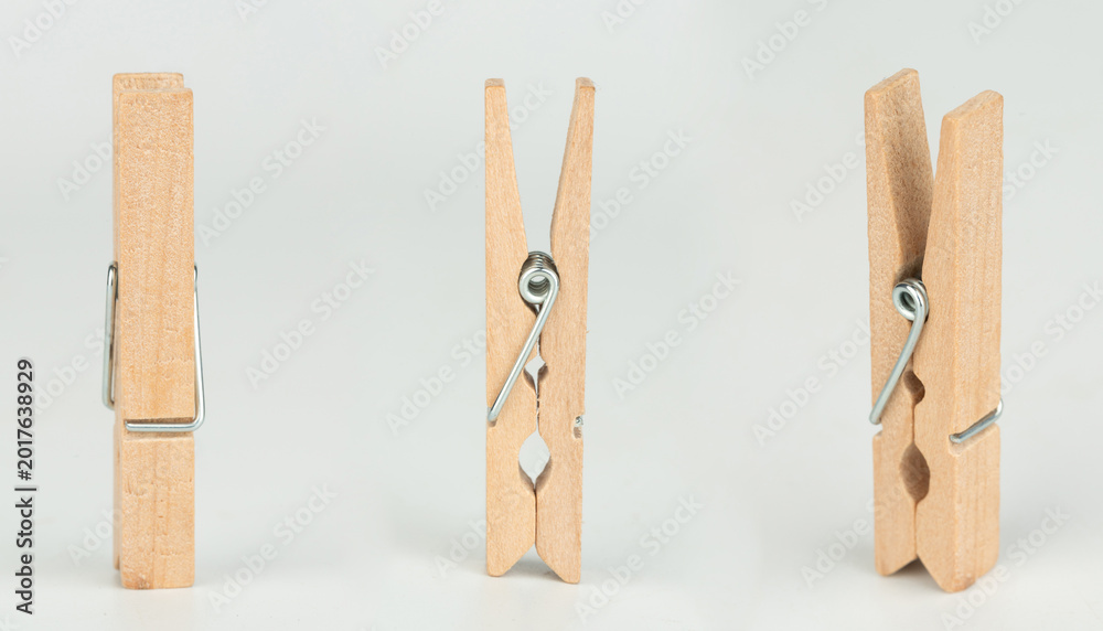 Obraz premium Clothespins in different positions isolated on a light background