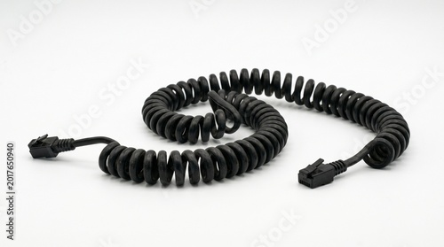 Black telephone curly cord closeup.