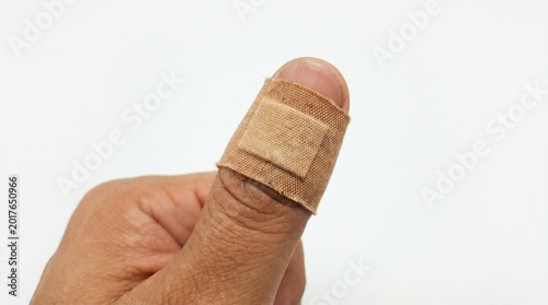 Bandaged finger on a human hand.