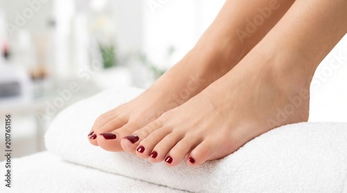 Woman receiving pedicure at salon.