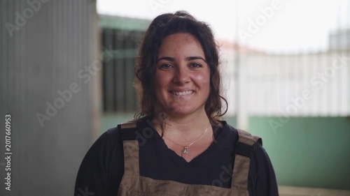 Attractive farmer poses for the camera smiling and blinking in slow motion