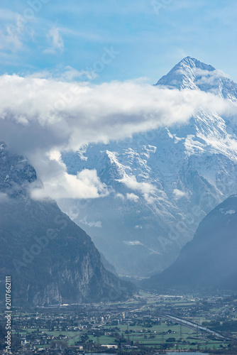Snowcovered alpine peak in swiss alps, broad mountain valley with a small town, dramatic highland landscape - Altdorf, Switzerland