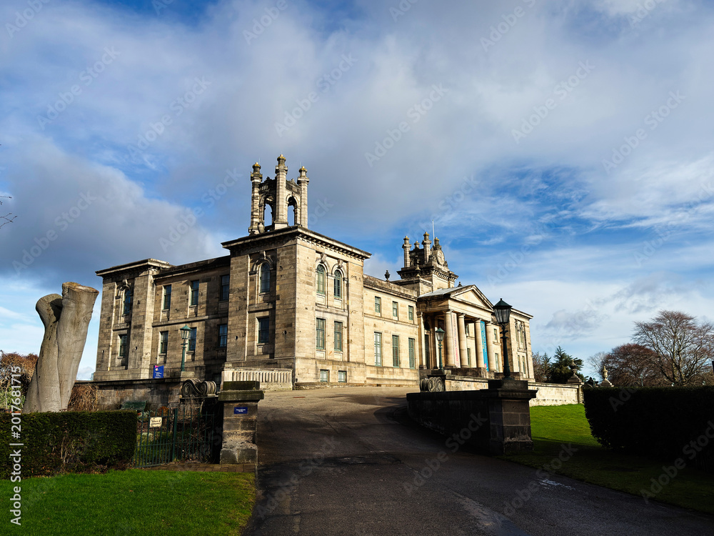 Obraz premium Grand neoclassical Modern Two mansion and historic estate house in Edinburgh, Scotland, UK with stone columns, portico and landscaped grounds under a dramatic cloudy sky