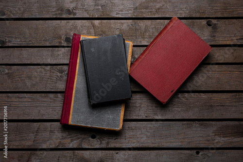 Vintage books on rustic wooden background