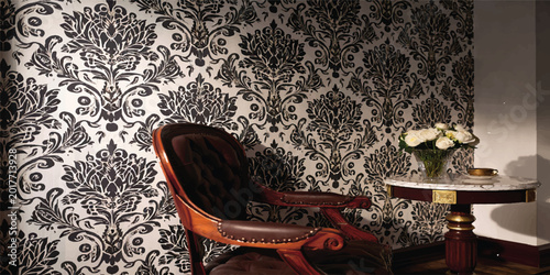 Fotografie Elegant antique armchair against a damask wallpaper pattern with wallpaper armch