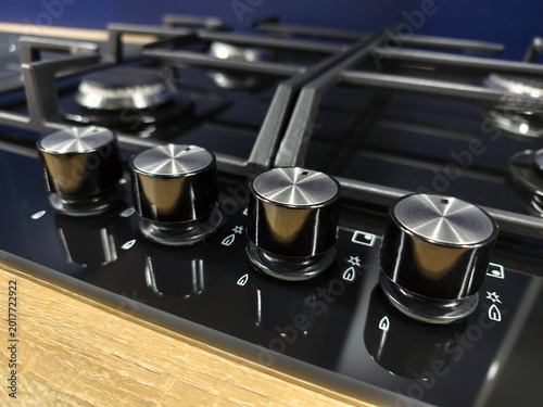 фотографія Gas stove control panel with knobs for temperature and flame, displayed in super