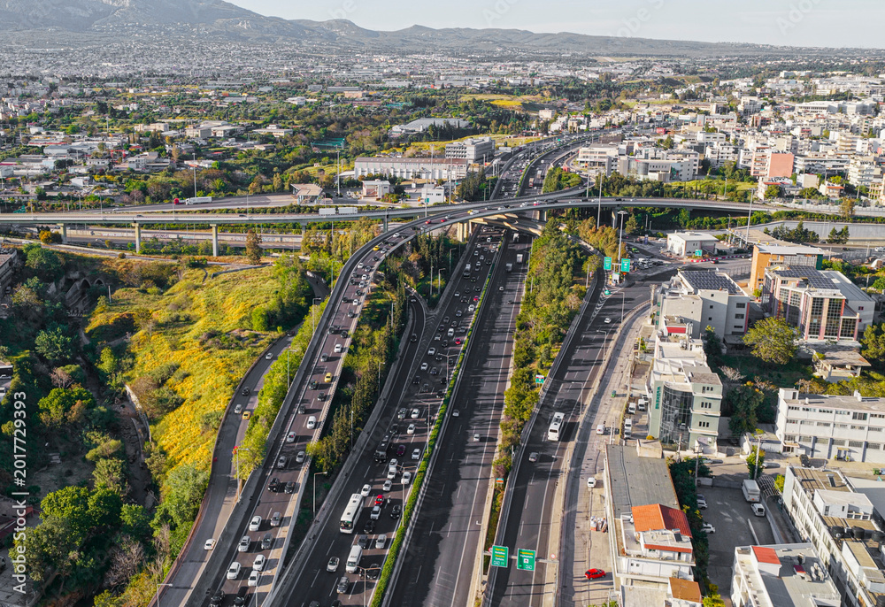 Fototapeta premium Modern complex freeway overpass system connecting multiple lanes of vehicles through a vibrant urban landscape