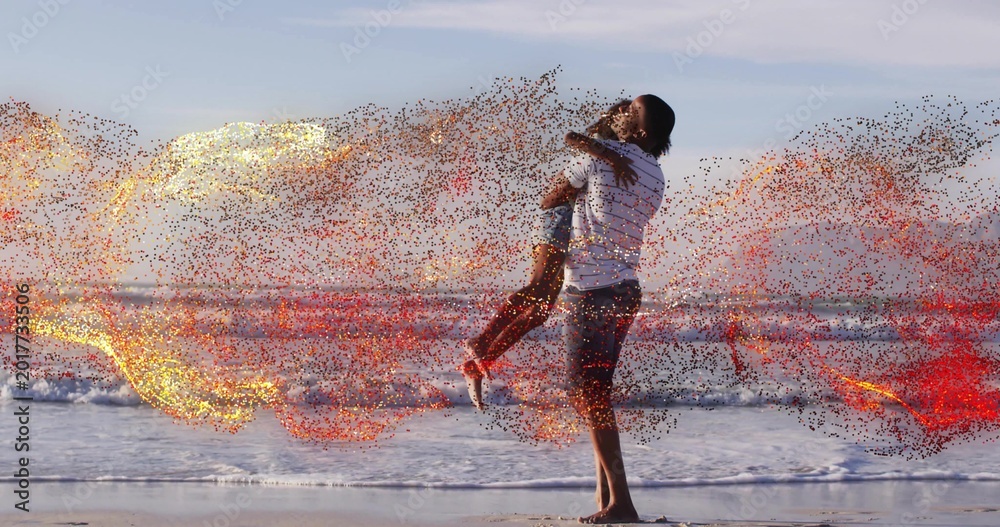 Fototapeta premium Lifting father holding daughter over wet sand at shoreline, striped shirt, sneakers, sparks