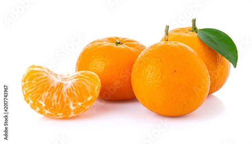 Several ripe, vibrant citrus fruits are presented against a clean white backdrop, with one segment revealed for texture