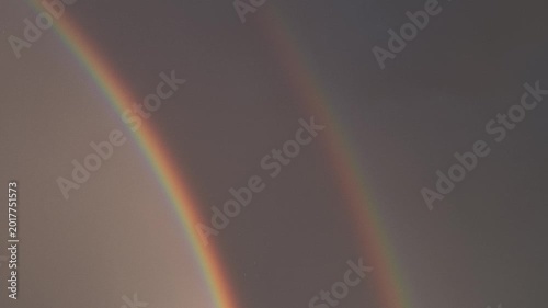 Vivid Double Rainbow After Rainstorm in the dark sky