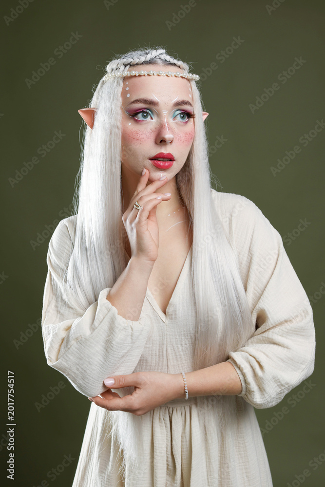 Fototapeta premium Beautiful elf girl on dark olive background