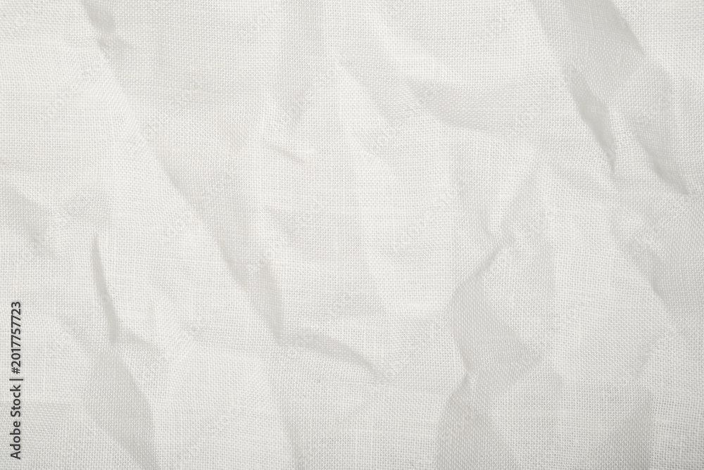 Fototapeta premium Wrinkled white canvas fabric texture with visible woven pattern and soft folds. Clean textile background for mockups, branding and minimal design projects.