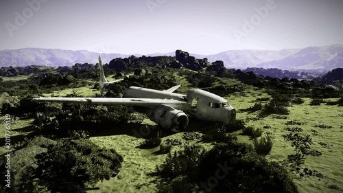 Abandoned transport plane resting on scrubby hillside near ancient fortress silhouette, cinematic light creates dramatic contrast and editorial mood for travel