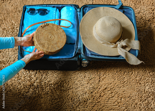 Photos Close up woman packing suitcase to vacation  getting ready to travel trip