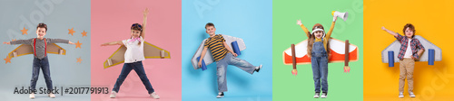 Photos Cute children with cardboard plane wings playing pilot