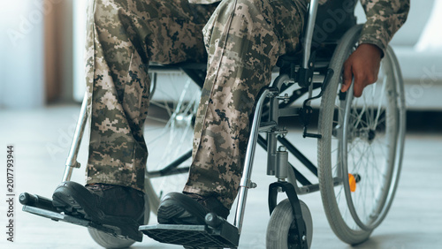 Foto A veteran sits in a wheelchair while wearing camouflage pants