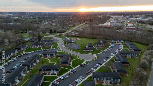 Konstfotografi Aerial sunset view of suburbia - residential houses at dusk under sunset sky