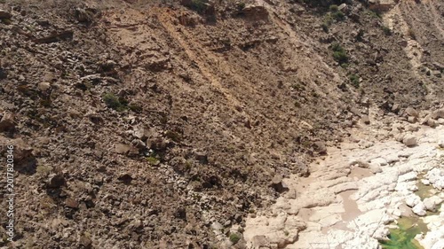 Aerial close-up video of a steep rocky mountain slope on socotra island.
