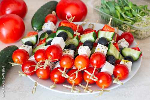 Colorful appetizer skewers with cherry tomatoes cheese olives and cucumbers
