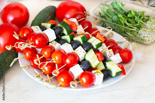 Healthy vegetable and cheese skewers with cherry tomatoes and olives