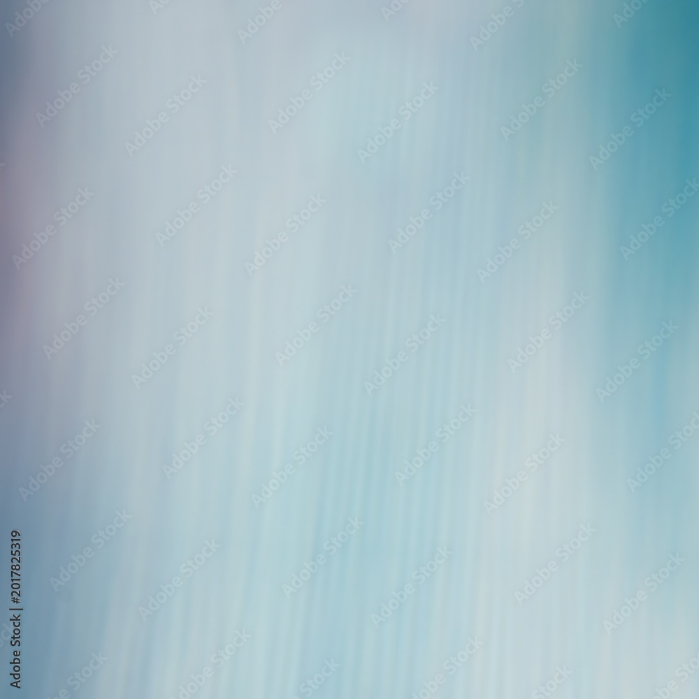 Fototapeta premium Soft blue abstract background with vertical motion blur texture