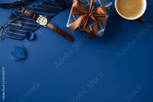 Happy Father's Day gift flat lay with watch, tie, gift box, ribbon and coffee