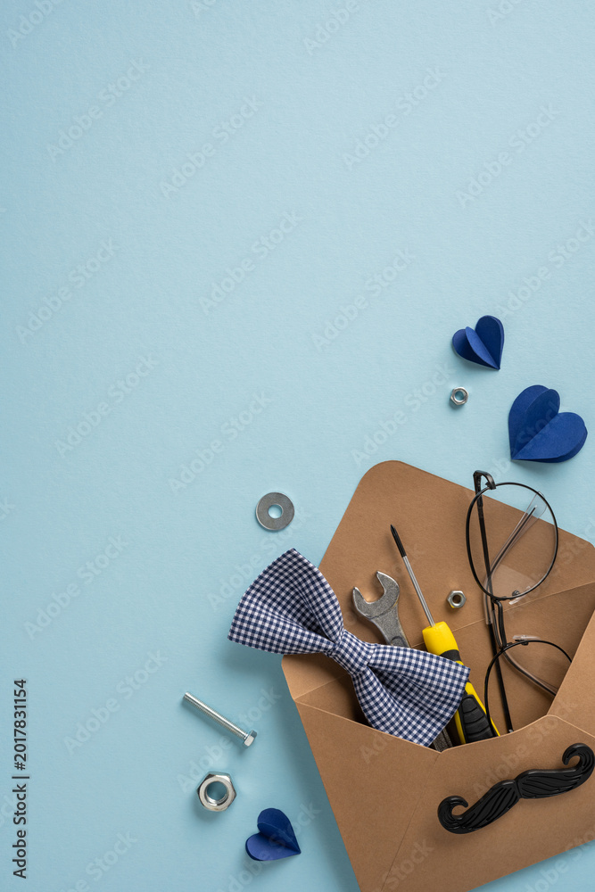Fototapeta premium Happy Father's Day vertical gift envelope with bow tie, tools, glasses and mustache card