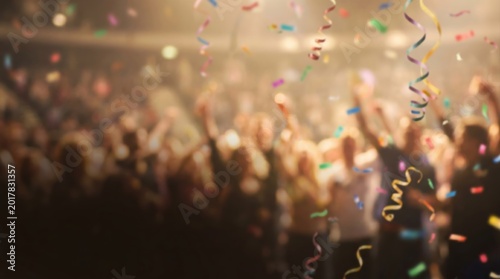 Colorful Confetti and Streamers Falling Over Excited Crowd at Party Celebration Event