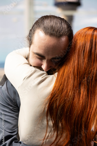 Konstfotografi Emotional airport reunion with couple embracing upon arrival, hugging and smiling in intimate moment